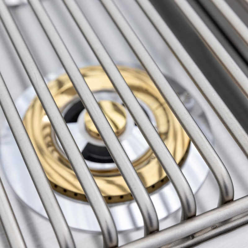 Close-up of brass burner below stainless steel cooking grate on Blaze LTE+ double side burner