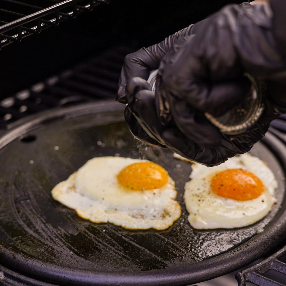 Monument Grills round cast iron cooking plate in use