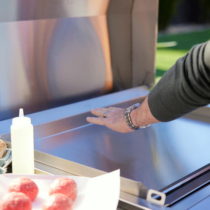 Hand checking heat above the reinforced stainless steel surface of the Blaze LTE PRO griddle