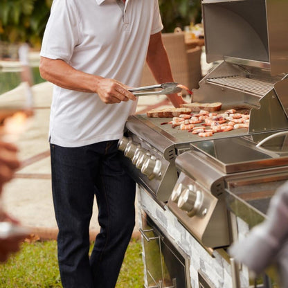 Person cooking on a Blaze LTE+ stainless steel gas grill