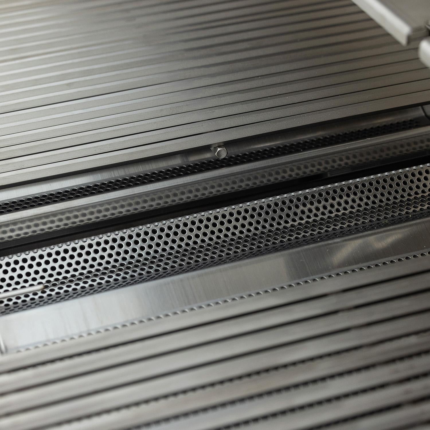 Close view of the hexagonal cooking grates and flame tamers