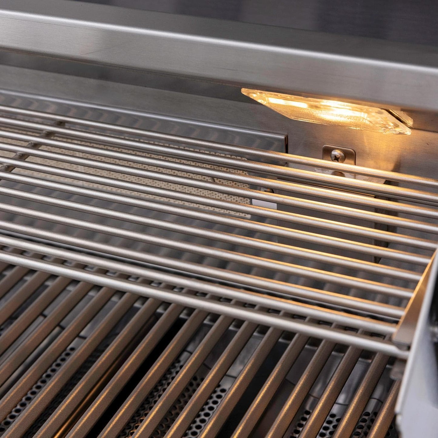 Interior grill light illuminating the stainless steel cooking grates