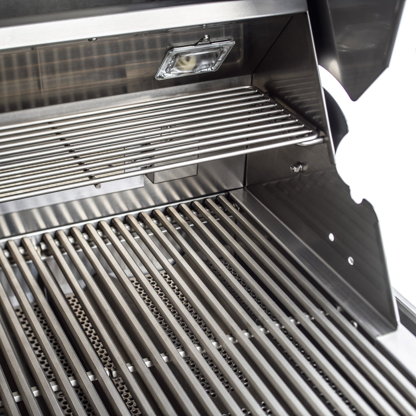 Open Blaze Professional LUX grill showing cooking rods, warming rack, and interior light