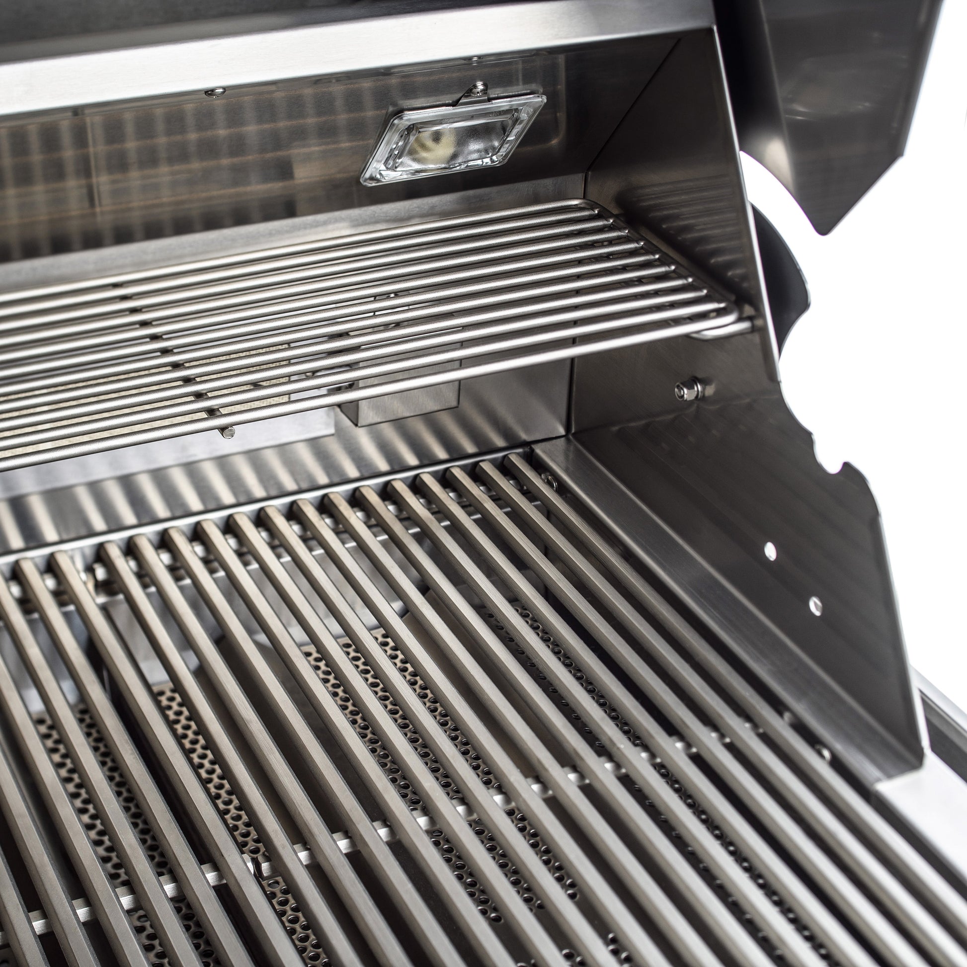 Open Blaze Professional LUX grill showing cooking rods, warming rack, and interior light