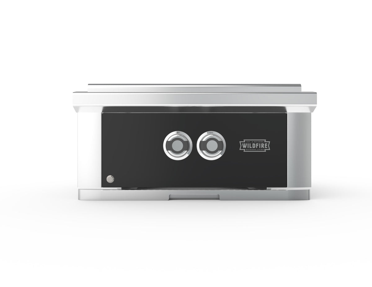 A Wildfire outdoor fireplace with a black front panel, two circular control dials, and a brushed silver metal frame, shown against a plain white background.