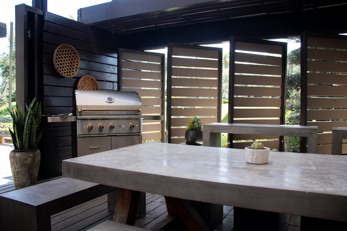 Wildfire Ranch Pro grill on a stainless steel Wildfire grill cart in a covered outdoor dining area
