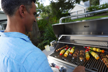 Grilling vegetable skewers on the Bull Brahma