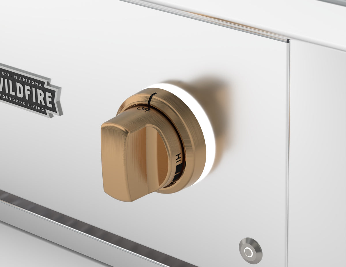 Wildfire replacement knob and base in Brushed Bronze finish, installed on a stainless steel control panel