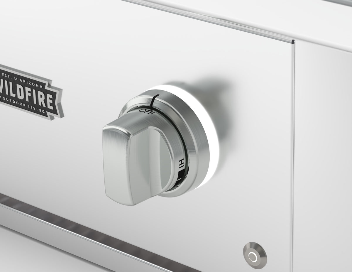 Wildfire replacement knob and base in Brushed Stainless finish, installed on a stainless steel control panel