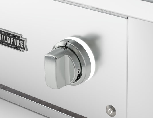Wildfire replacement knob and base in Brushed Stainless finish, installed on a stainless steel control panel