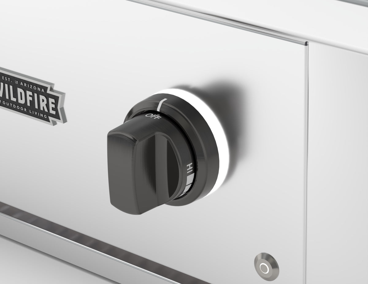 Wildfire replacement knob and base in Chrome Black finish, installed on a stainless steel control panel