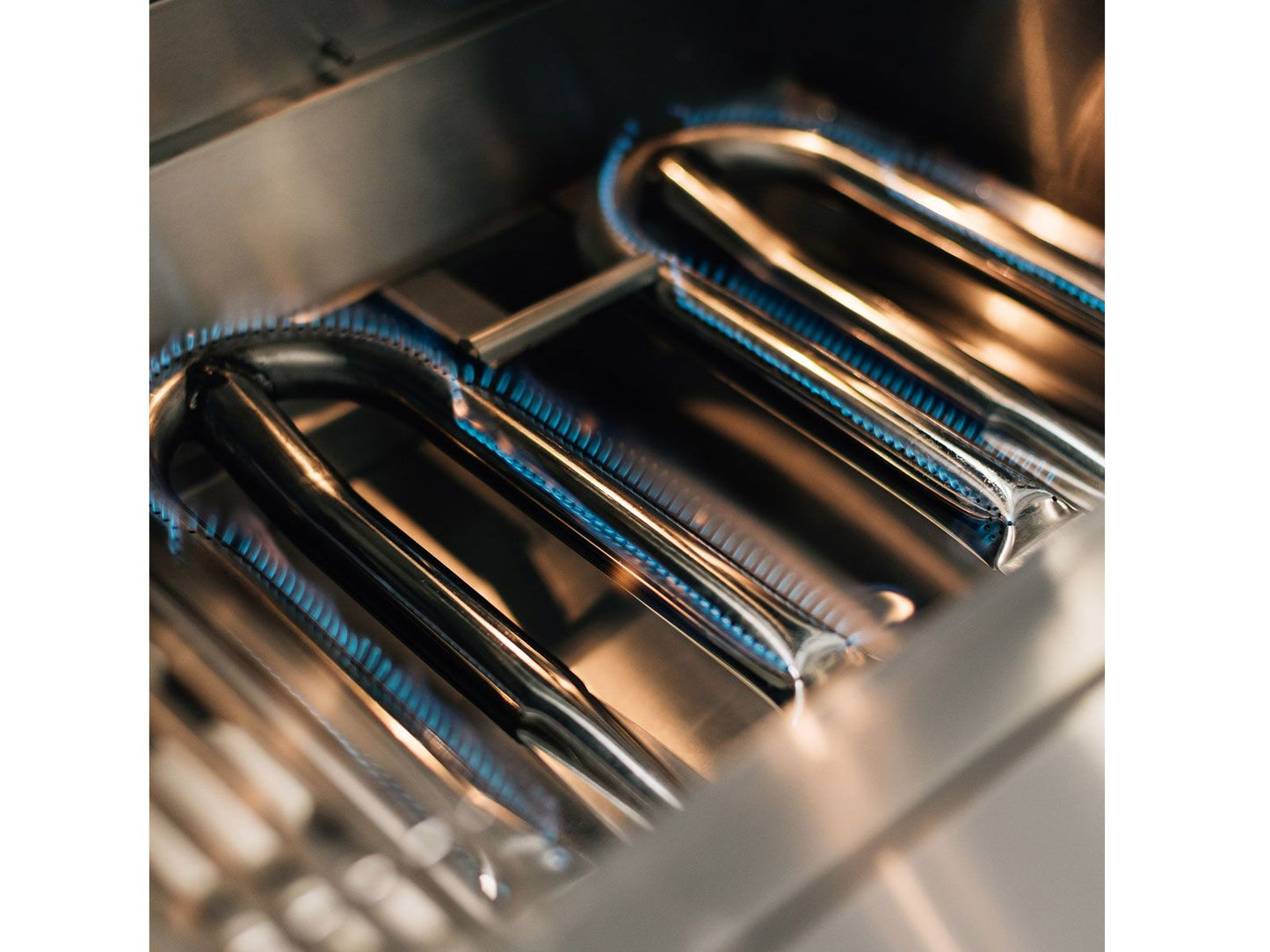 Stainless steel U-tube burners inside a Summerset Quest gas grill