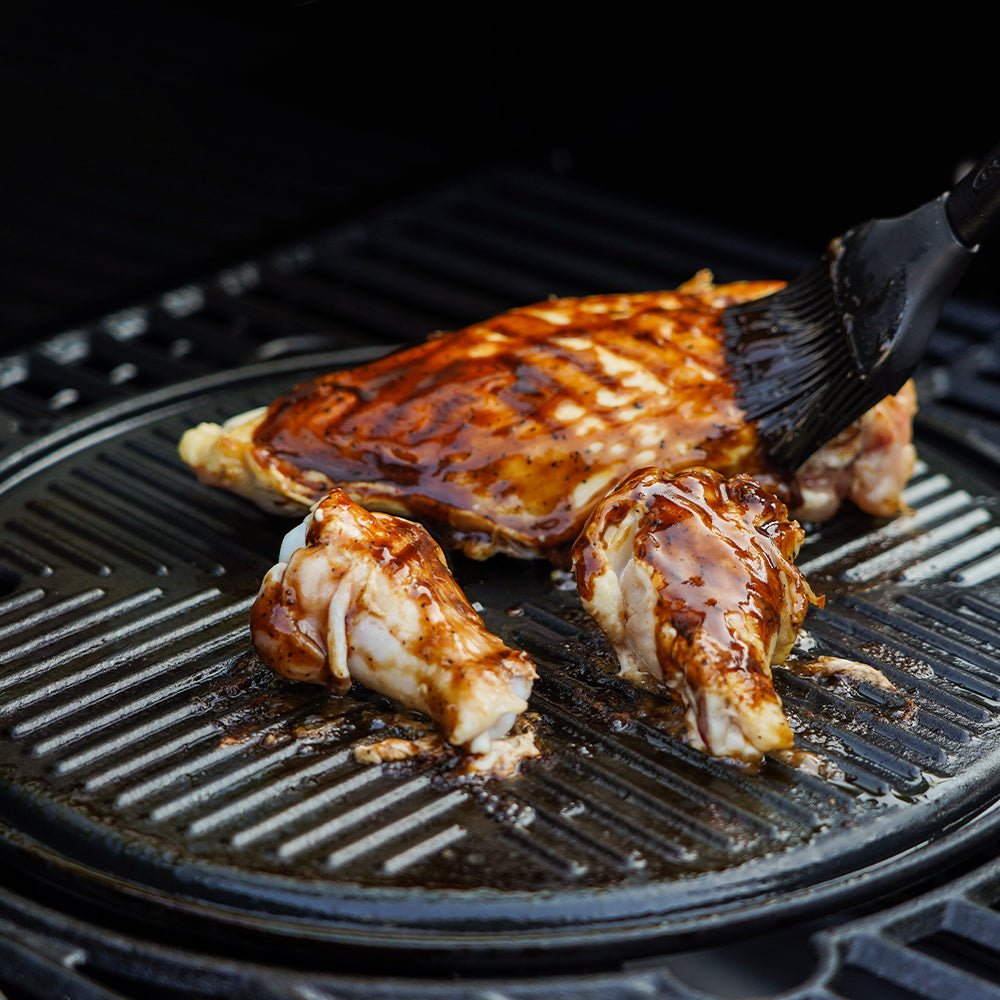 Monument Grills round cast iron cooking plate in use