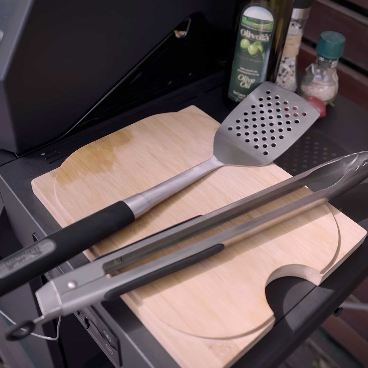 Monument Grills stainless steel tongs and spatula in use