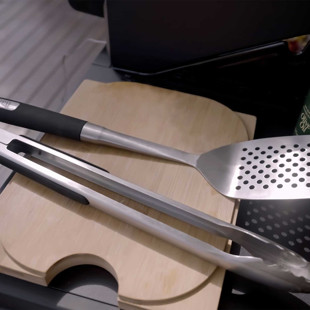 Monument Grills stainless steel tongs and spatula in use