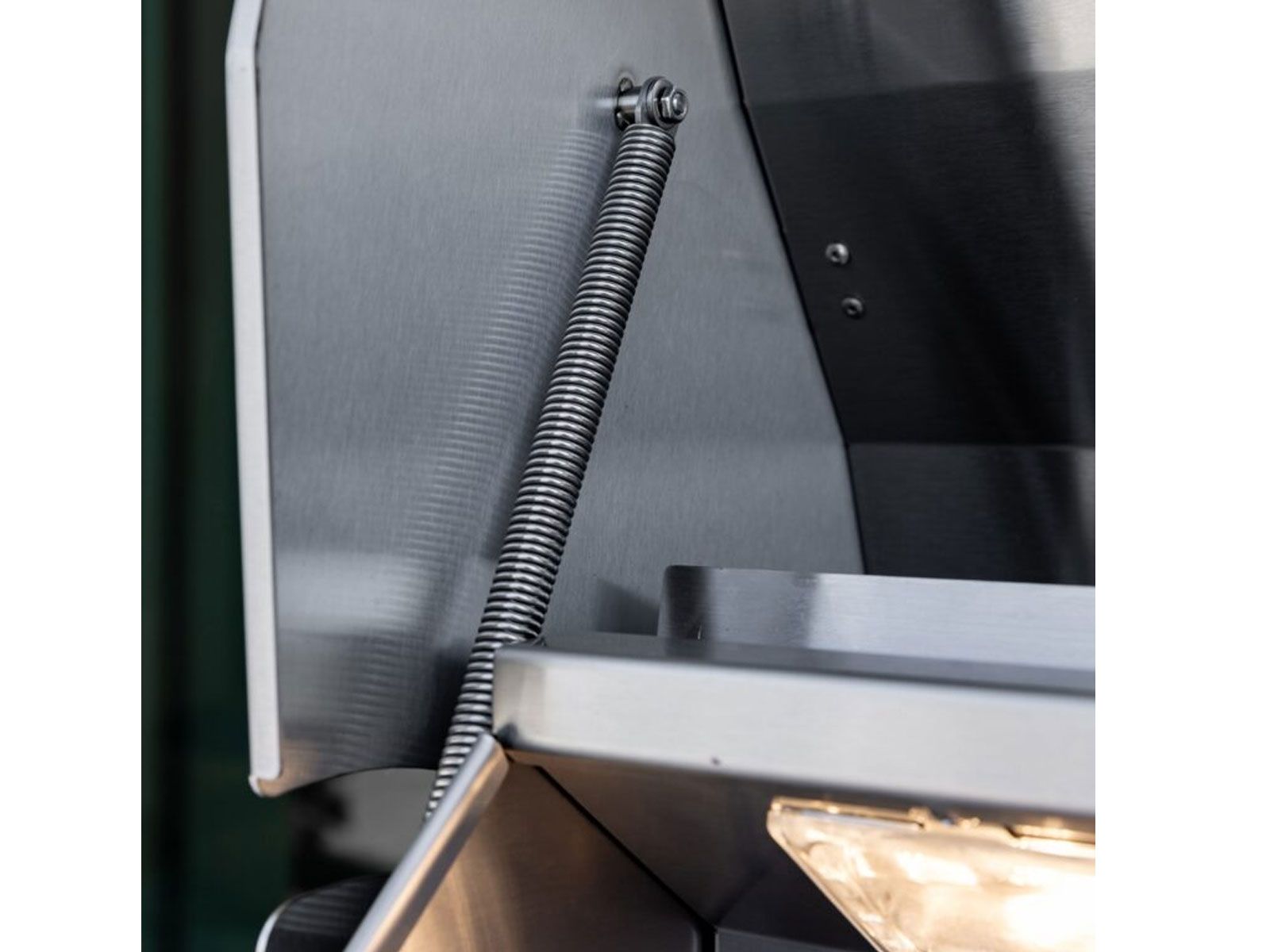 Spring-assisted hood hinge on a Summerset TRL Pro gas grill